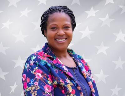 An image of Alonna Berry smiling in a shirt and blazer.