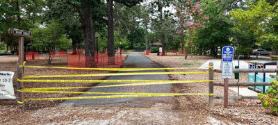 Yellow no crossing tape blocks off the entrance to the park.