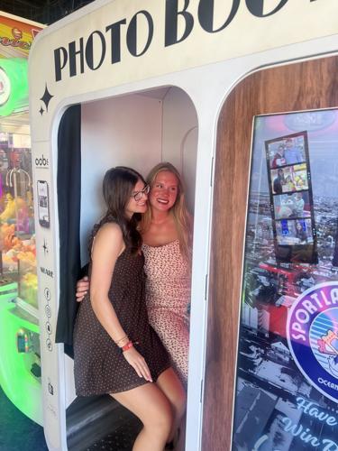Two girls take a photo in the photo booth.
