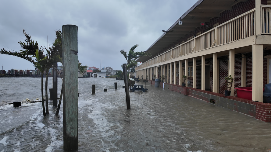 Water flooding from the ocean up to a building.