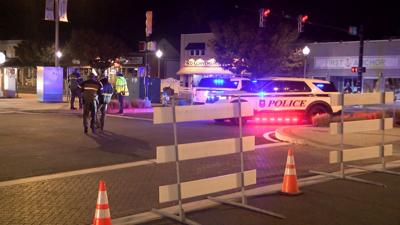 Barricades on Rehoboth Ave. On the left are Rehoboth Beach police officers and vehicles.
