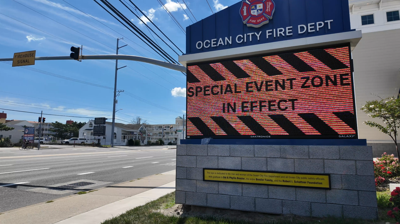 An LED sign in front of the Ocean City Fire Department displaying warnings of a Special Event Zone being in effect. 