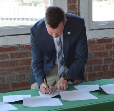 Delaware State Forester Kyle Hoyd signing the Chesapeake Bay Shared Stewardship Agreement.
