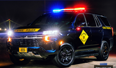 A police car with lights flashing at night.