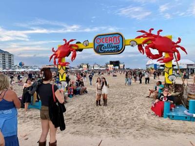 An entrance to Oceans Calling Festival featuring an archway and sign. 