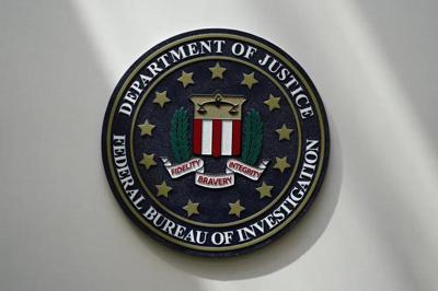 FILE - An FBI seal is seen on a wall on Aug. 10, 2022, in Omaha, Neb. The FBI sounded the alarm Monday, Dec. 19, about an explosive increase in teenage boys being targeted online and extorted for money after being tricked into sending sexually explicit ...
