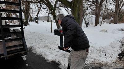 Man shoveling snow in Milton
