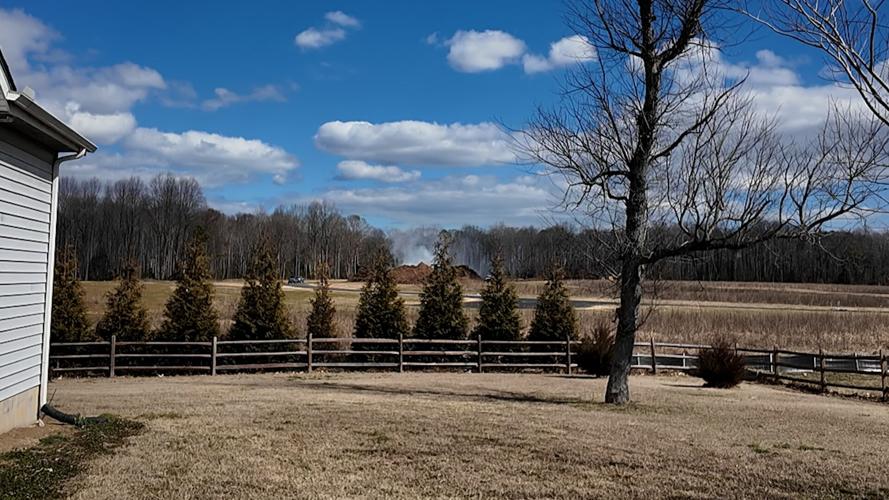 A shot of the burning pile of mulch from a driveway in Lincoln