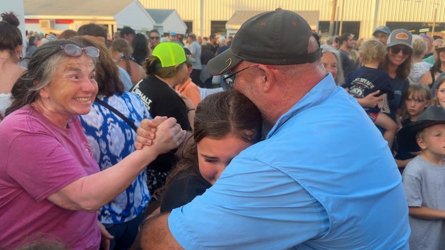 Young girl hugging her father after win.