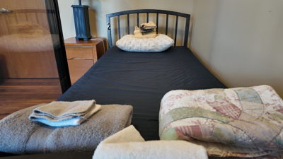 A bed with blankets folded on top.