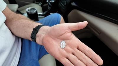 Mike McGlynn carries a medallion blessed by Pope Francis every day for protection.