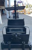 A car from a haunted mansion ride. The all black car has a skull and crossbones on the front.