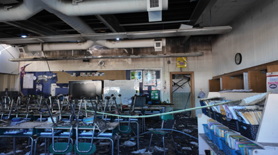 burned classroom after fire with chairs on table