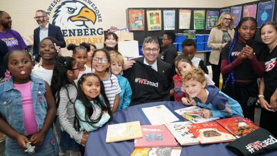 An image of Governor Meyer with elementary students announcing a pilot program. 