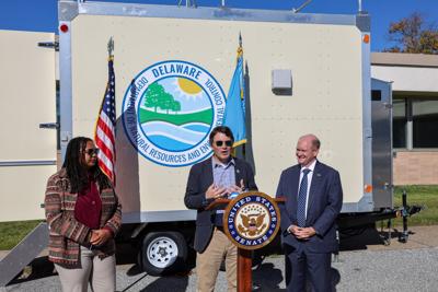 people speaking in front of a dnrec unit 