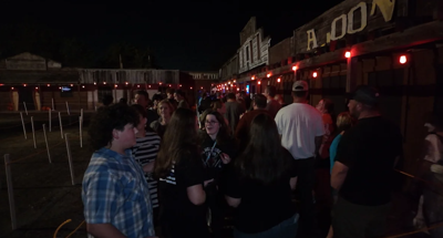 People gather outside of the haunted house.