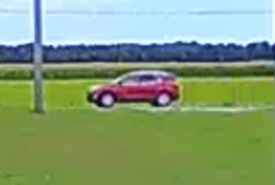 Red car driving.