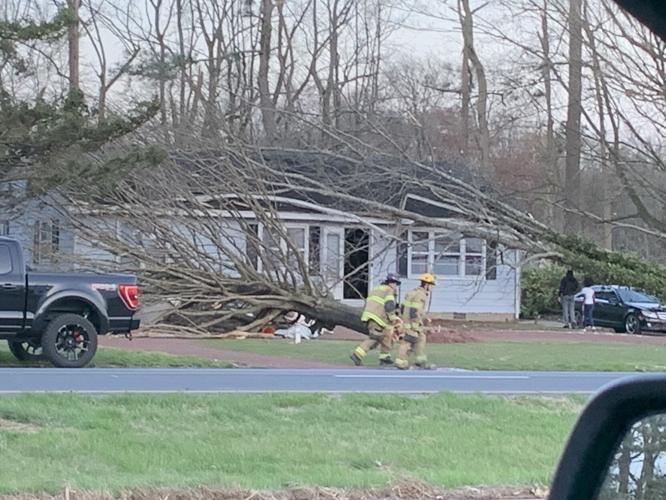 First responders working to remove trees on a house near Bridgeville on Sunday.