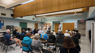 A room full of community members listening to a coastal preparedness symposium. 
