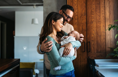 Man and woman hold newborn baby