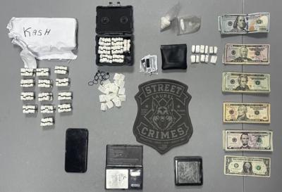 Seized cash, multiple bags of heroin, crack cocaine, digital scales, a cellphone