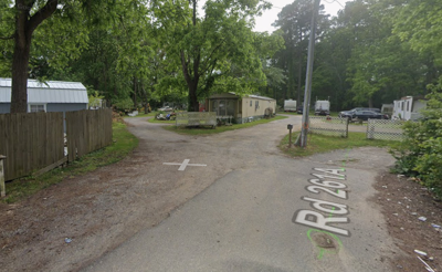 A street view of multiple trailers at the end of a road.