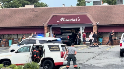 Truck fully crashed into front of the building.