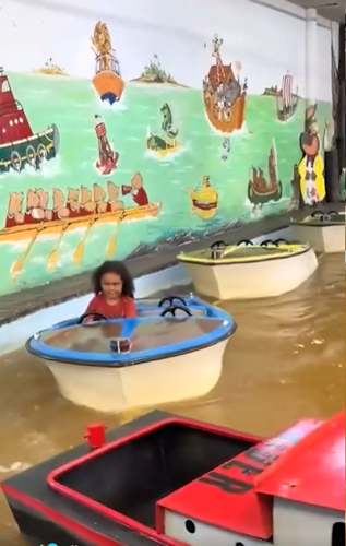 Kid riding through brown water