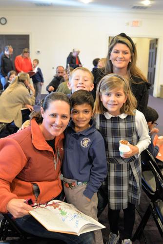 Second graders Dev Pillai, center, from Lewes; Margot Hidell, right, from Rehoboth Beach; and Kamden White, back, from Millsboro shared their stories with family and friends like Darcy Pillai, left, and Ashlee Hidell, back right. Courtesy Worcester Prep...