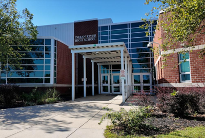 An entrance to the Indian River High School on a sunny day.