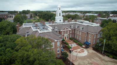 U shaped brick building with white top 