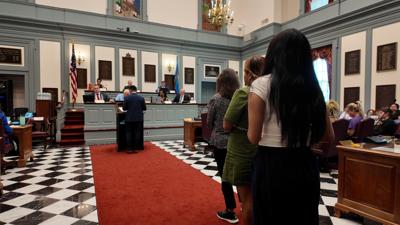 Supporters of House Bill 182 line up to speak during the Senate Executive Committee hearing at Legislative Hall on Thursday, voicing their support for the bill.