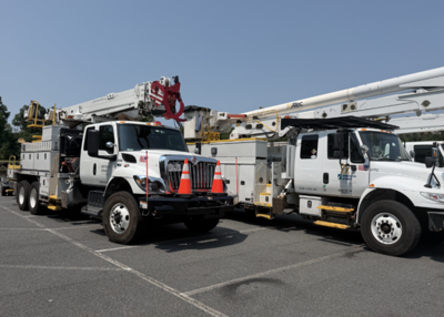 Two utility trucks parked side by side.