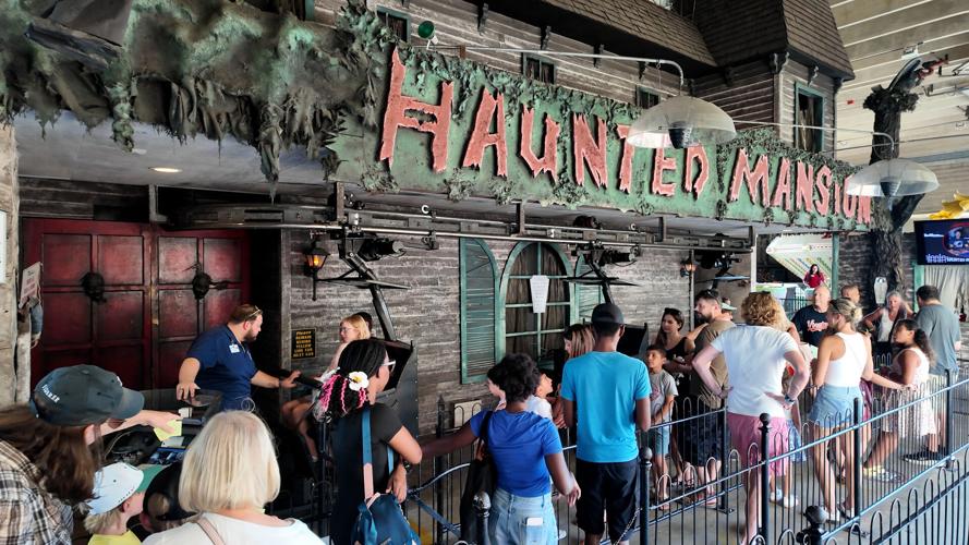 People lined up ready to get on the Haunted Mansion ride.