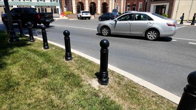 Cars driving around the Georgetown Circle, which is now protected by black bollards
