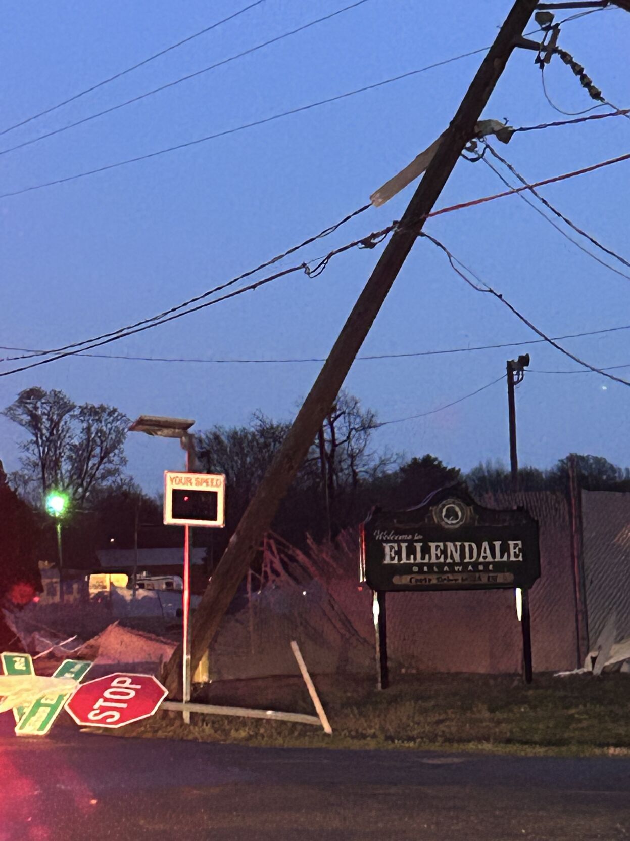 A photo taken Saturday around 8 p.m. shows a utility pole leaning sideways in Ellendale. Courtesy Kyle Gross.