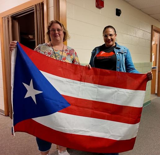 Teachers holding the Puerto Rican flag during the parade.