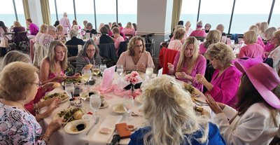 women dressed in pink dine at the luncheon 