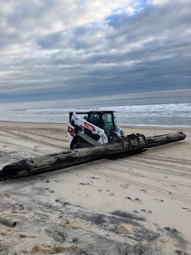 Skidloader with power line on the beach