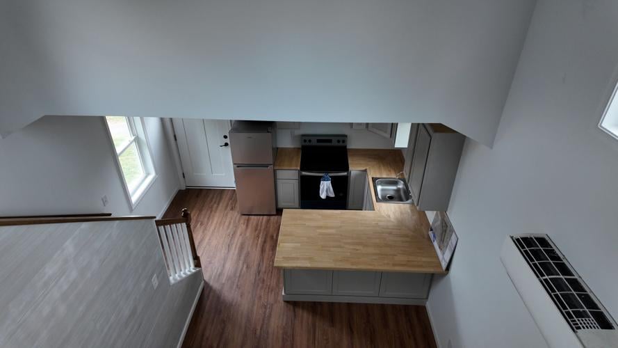 A view of the kitchen and part of the living room in one of the model cottage homes.
