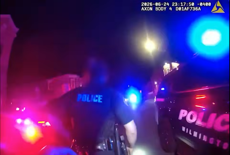Police at crime scene with flashing lights.