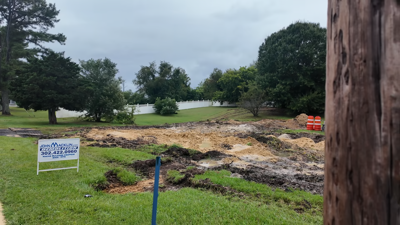 A piece of property with dug up grass where a house was just demolished.