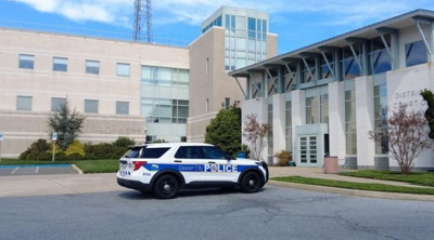 A police car parked outside of a police station.