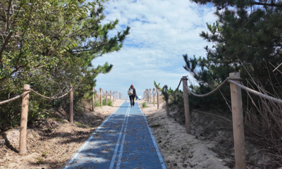 A person walking onto Bethany Beach