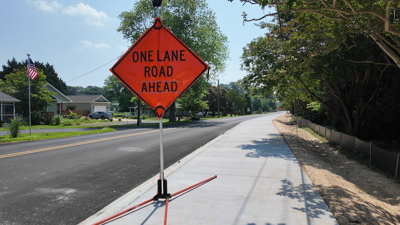 One lane road ahead sign