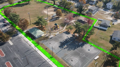 An aerial view of the park with a green line showing where the trail will be.
