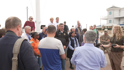 Photo of Governor Matt Meyer answering question on the Bethany Beach Boardwalk.