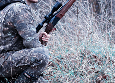 MAN IN CAMO HOLDING GUN