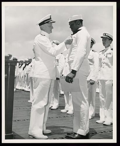 Dorie Miller receiving Navy Cross from Admiral Nimitz