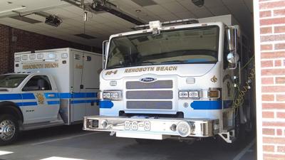two emergency vehicles pictured are parked, they have rehoboth beach markings on the front of the trucks 